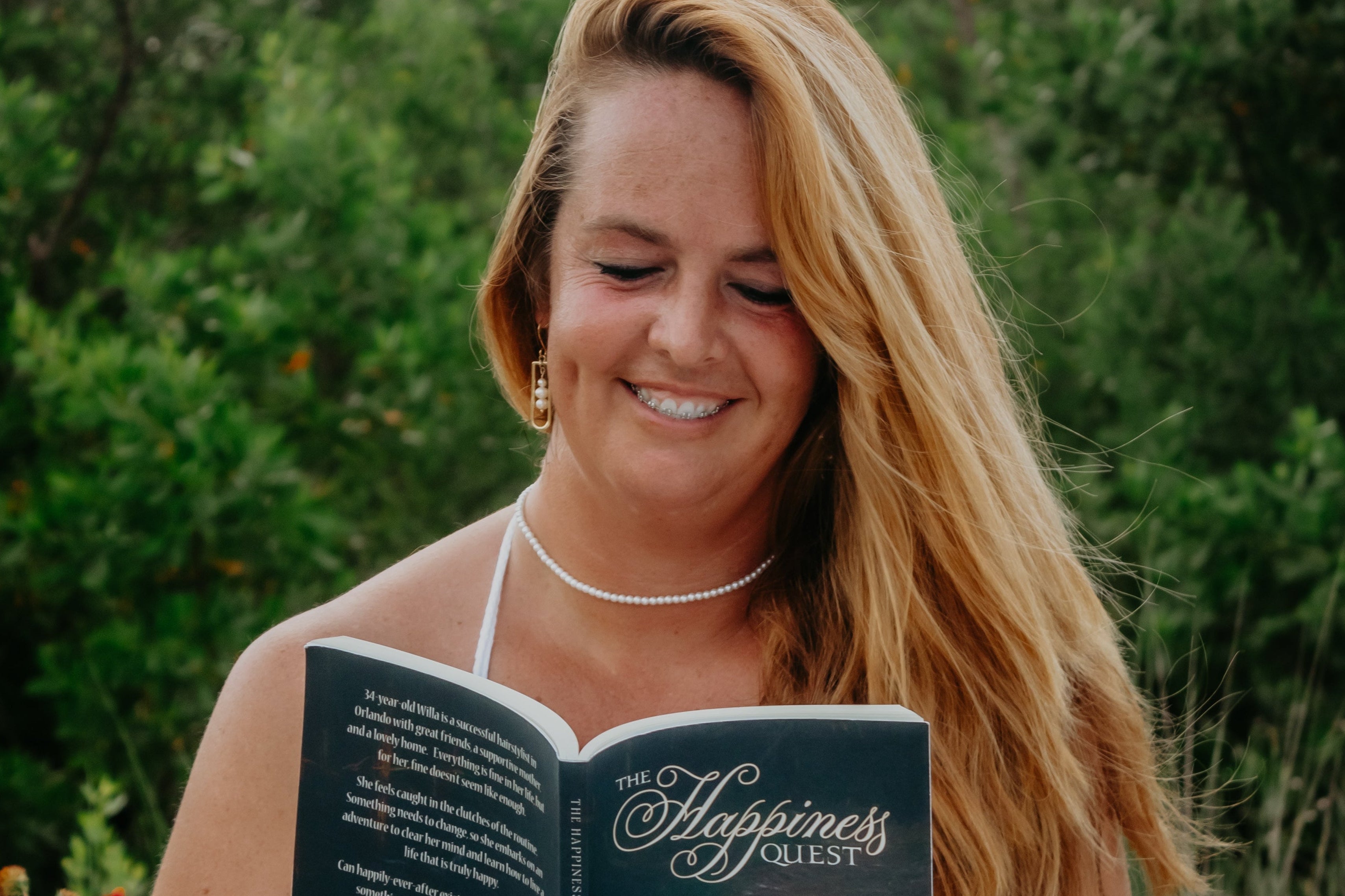 Woman reading a book outdoors in a natural setting